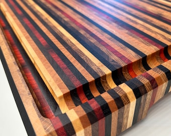 Handmade XXL cutting and presentation board in 6 end-grain wood species, brass feet, customization available.