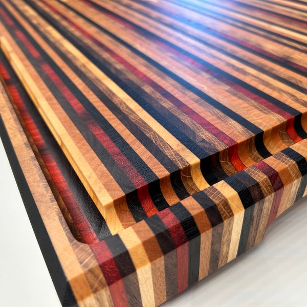 Handmade XXL cutting and presentation board in 6 end-grain wood species, brass feet, customization available.