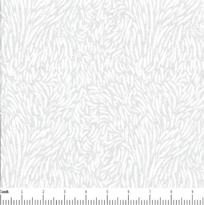 May include: A white fabric featuring a repeating pattern of light gray, elongated, curved, leaf-like shapes arranged in a dense, flowing design. A ruler at the bottom shows a scale of 9 inches, indicating the size of the textile pattern.