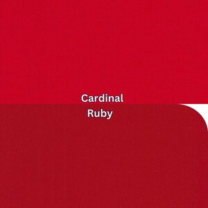 May include: Two red fabric swatches, one cardinal red and the other ruby red. The text "Cardinal" and "Ruby" are displayed in white font, indicating the colour names. The fabric appears to have a subtle texture.