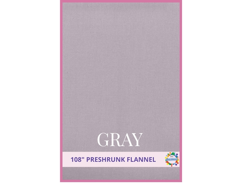 May include: A gray preshrunk flannel fabric with a pink border. The word "GRAY" is displayed in white, centered on the fabric. The text "108" PRESHRUNK FLANNEL" is below the word "GRAY".