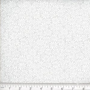 May include: A light gray fabric featuring a repeating pattern of white daisy-like flowers. A ruler is positioned along the bottom edge, showing a scale of 8 inches, providing a clear visual reference for the size of the floral print design.