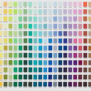 May include: A large color chart featuring a wide spectrum of hues, arranged in a grid. The chart displays a variety of colors, from vibrant reds and oranges to cool blues and greens, with each color presented in a small, square swatch. The chart includes the text "RK" and "36 NEW COLORS".