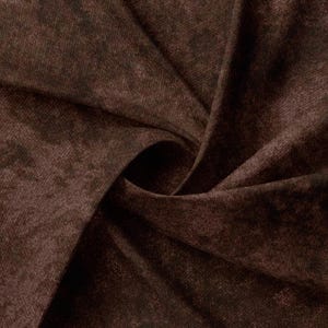 May include: Close-up of a brown fabric with a textured, slightly mottled appearance. The fabric is folded and draped, showing its soft, drapey texture.