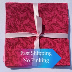 May include: A stack of pink fabric squares with a floral pattern, tied with a pink ribbon. The fabric is pre-cut and ready to use for quilting or other crafts. The text "Fast Shipping No Pinking" is visible on a blue arrow.