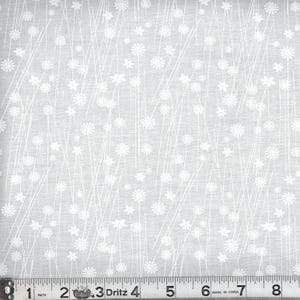 May include: A light gray fabric featuring a repeating pattern of white line-drawn flowers and thin vertical stems. A Dritz brand measuring tape is positioned at the bottom, showing a scale of 8 inches across the width of the textile material.