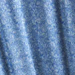May include: A blue fabric with a white swirl pattern. The fabric is soft and has a subtle sheen.