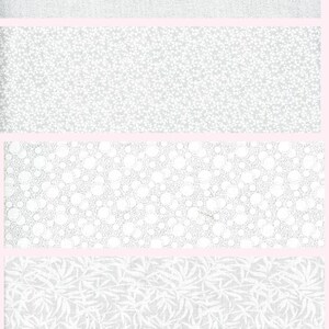 May include: A White on White Fat Quarter Bundle featuring ten stacked fabric swatches. Each piece of fabric is white with subtle white patterns including floral swirls, polka dots, small blossoms, leaves, and geometric textures. The text reads White on White Fat Quarter Bundle.