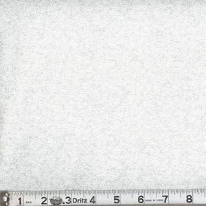 May include: A light gray fabric featuring a dense, repeating white pattern of small, delicate leaves and vines. A Dritz measuring tape is positioned along the bottom edge, showing a scale in inches that extends past 8 inches in total length.