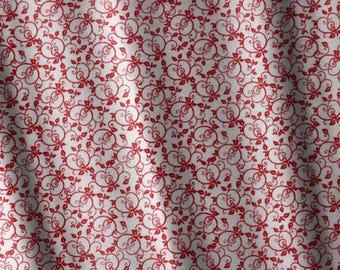 May include: A white fabric featuring a repeating pattern of deep red swirling vines and small leaves. The material displays soft folds and drapes, creating subtle shadows across the surface of the textile while maintaining a consistent print.