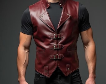 May include: A burgundy leather vest with a high collar and three buckle closures. The vest has a tailored fit and is worn over a black t-shirt. The vest is a classic style, suitable for various occasions.