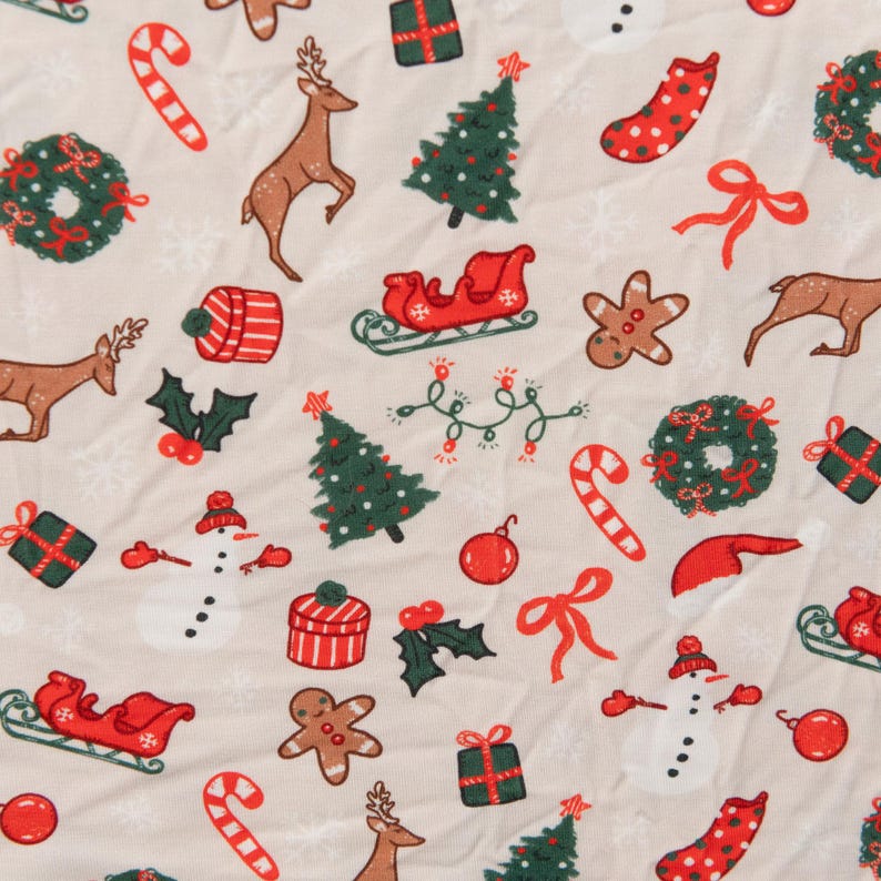 May include: A beige fabric with a repeating pattern of Christmas-themed illustrations. The pattern includes reindeer, Christmas trees, candy canes, presents, snowmen, gingerbread men, wreaths, and holly.