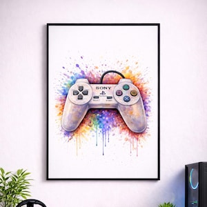 May include: A framed print depicting a PlayStation controller in a watercolour style. The controller is white with black buttons and the Sony logo. It is set against a vibrant splash of paint, with colourful drips cascading downwards.