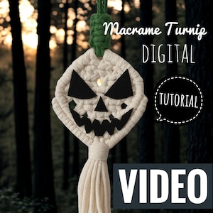 May include: A macrame turnip decoration with a carved face design, featuring black felt eyes and mouth. The off-white macrame piece is suspended by a green cord, with the words "DIGITAL TUTORIAL VIDEO" displayed.