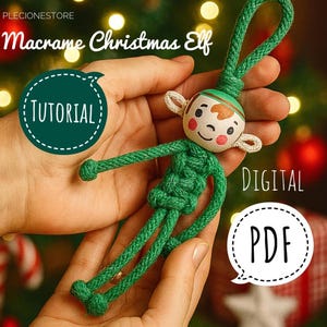 May include: A handmade macrame Christmas elf with a green body, arms, and legs, and a wooden head with painted facial features. The elf is held in two hands against a blurred background of Christmas lights and decorations. The text "Macrame Christmas Elf" and "Tutorial" are visible.