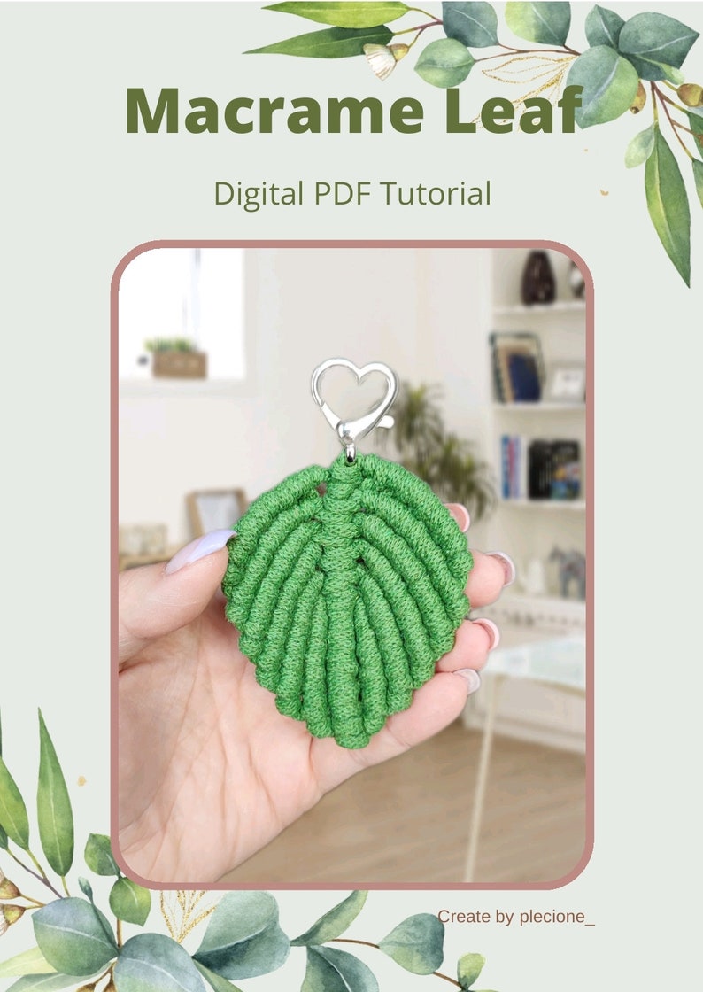 May include: A green macrame leaf keychain with a silver heart-shaped clasp. The keychain is being held in a hand. The image includes the text "Macrame Leaf" and "Digital PDF Tutorial".