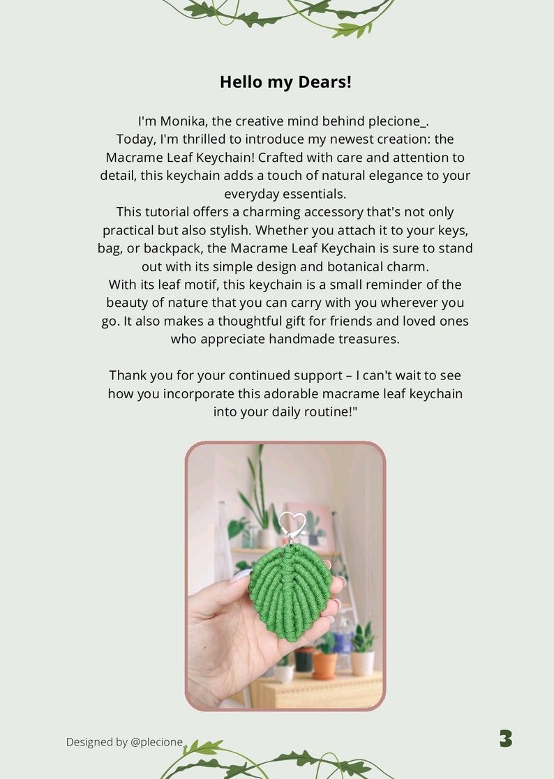 May include: A green macrame leaf keychain with a silver ring. The keychain is hanging from a hand in front of a shelf with potted plants.