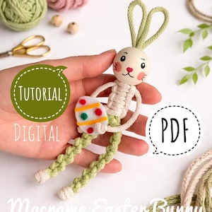 May include: A macrame Easter bunny, featuring a wooden head and a decorated egg. The bunny has green braided legs and ears. The image includes the text "Tutorial Digital PDF" and "Macrame Easter Bunny".