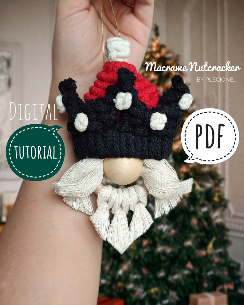 May include: A macrame nutcracker ornament with a red and black crown, white beard, and wooden bead nose. The ornament is held in a hand against a blurred background of a Christmas tree. The text "Macrame Nutcracker" and "PDF" are visible in the image.