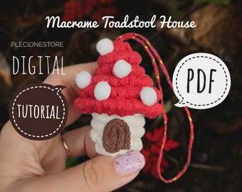 May include: A red and white macrame toadstool house with a brown door. The house is hanging from a gold cord. The image includes the text "Macrame Toadstool House", "DIGITAL TUTORIAL", and "PDF".