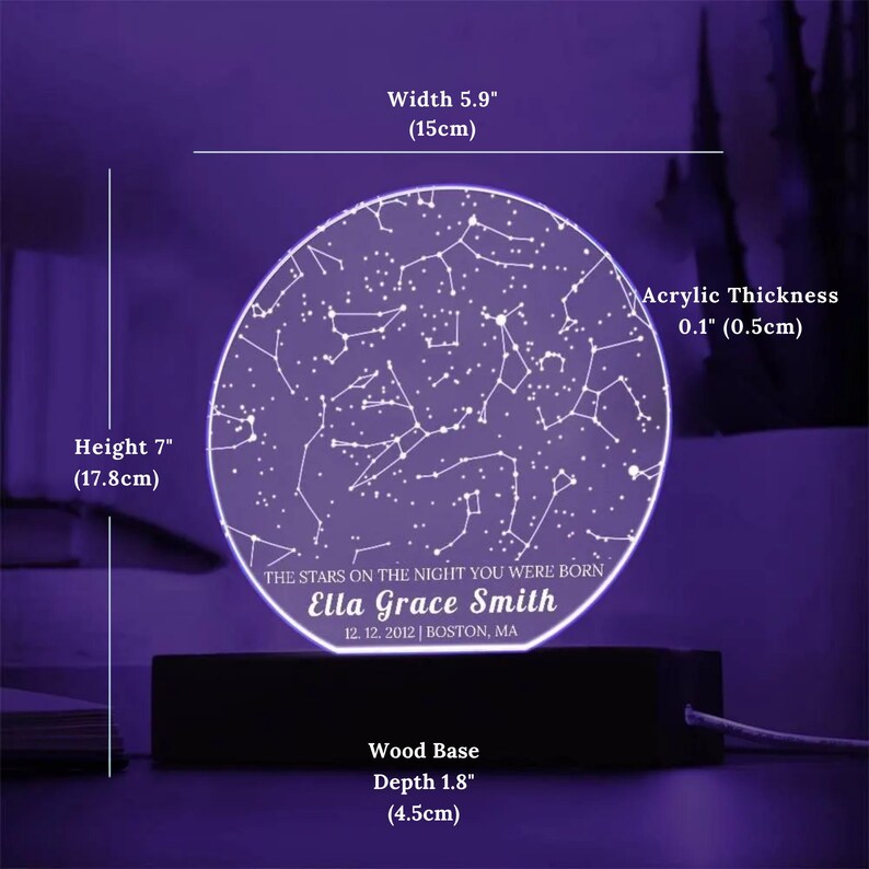 May include: A personalized night light featuring a constellation design. The acrylic display is 5.9 inches (15cm) wide and 7 inches (17.8cm) tall, with a 0.1-inch (0.5cm) thickness. It includes a wooden base with a depth of 1.8 inches (4.5cm). The text reads: "THE STARS ON THE NIGHT YOU WERE BORN Ella Grace Smith 12.12.2012 | BOSTON, MA."