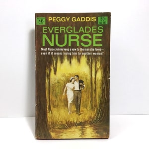May include: A vintage paperback book cover with a green and brown background. The title is "Everglades Nurse" and the author is Peggy Gaddis. The cover features a couple walking through a swampy area.