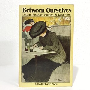 May include: A vintage book titled "Between Ourselves: Letters Between Mothers & Daughters." The cover features an illustration of a woman writing at a table. The book has a yellow cover with black text and a vintage illustration.