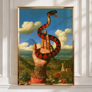 May include: A framed art print depicting a hand adorned with an ornate gold cuff and rings, holding a coiled snake with red and black diamond patterns. The background features a landscape with a blue sky, white clouds, and a distant mountain.