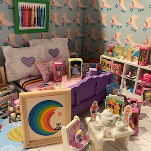 May include: A dollhouse bedroom featuring a purple bed, a white bedside table with a tea set, and a bookshelf stocked with dolls and books. The walls are adorned with a blue and white wallpaper featuring roller skates.