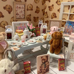 May include: A miniature teddy bear tea party scene. Includes teddy bears, a tea set, and miniature food items on a light blue table. The background features teddy bear wallpaper and framed pictures, creating a whimsical atmosphere.
