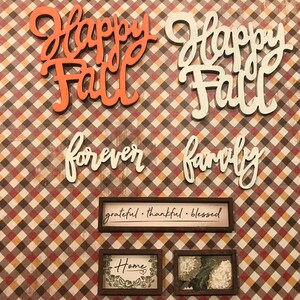 May include: A fall-themed craft project with the words "Happy Fall" in orange and white, "forever family" in white, and three framed signs that say "grateful. thankful. blessed", "Home", and a floral design.