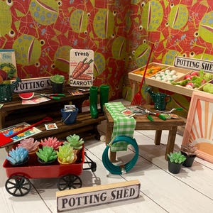 May include: A miniature potting shed scene featuring a red wagon with succulents, a wooden table with gardening tools, and a sign that reads "Potting Shed". The background has a red and green patterned wallpaper.