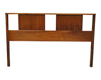 May include: A mid-century modern wooden headboard with a warm brown finish. The headboard features a rectangular design with two vertical panels and a horizontal top rail. The legs extend down from the base.