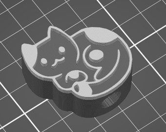 May include: A 3D printed charm of a curled up cat with white markings. The cat is in a sleeping position with its paws tucked under its chin.