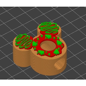 May include: A wooden toy shaped like Mickey Mouse with three red and green frosting-like decorations on top.