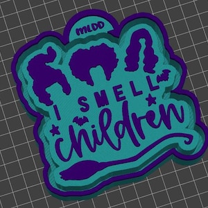 May include: A layered, teal, purple, and white Halloween-themed design with the text "I SMELL CHILDREN". The design includes silhouettes of witch hairstyles, a bat, a star, and a witch's broom. The letters "MLDD" are at the top.