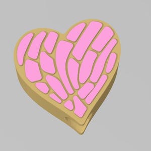 May include: A pink and gold heart-shaped cookie with a decorative pattern.