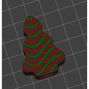 May include: A chocolate Christmas tree cookie decorated with green and red sprinkles.