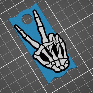 May include: A blue door hanger with a white skeleton hand making the peace sign.