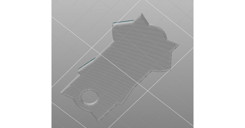May include: A gray 3D printed pendant with a circular cutout in the center and a unique, geometric shape.