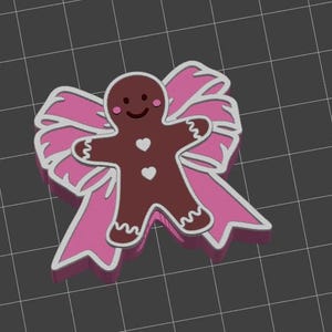 May include: A brown gingerbread man with a smiling face and two white heart-shaped buttons is centered on a pink bow with white trim. The design is set against a dark gray grid background.