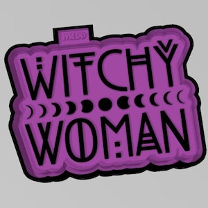 May include: Purple and black cookie cutter with the text "Witchy Woman" and moon phases.