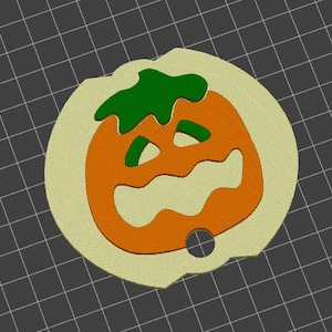 May include: A Halloween-themed pumpkin-shaped ornament. The ornament features an orange pumpkin with a carved face and green stem, set against a light tan background. A small hole is present at the bottom for hanging.