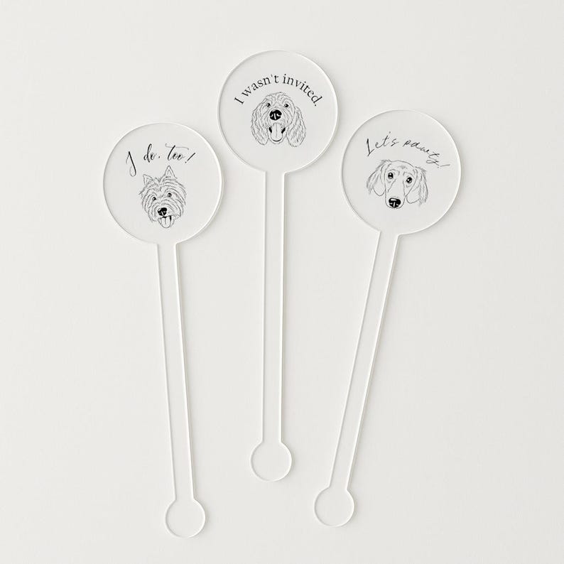 May include: Three clear acrylic drink stirrers with dog illustrations. One stirrer says "I do, too!" with a terrier, another says "I wasn't invited." with a poodle, and the last says "Let's pawty!" with a dachshund.