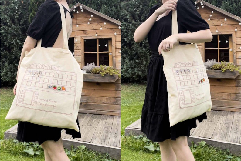 May include: A beige tote bag with a design of a video game inventory screen. The screen shows a grid of slots with icons of various items, including a mushroom, a heart, a strawberry, a tomato, and a peach. The text "Current Funds" and "Total Earnings" is visible on the screen.