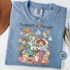 a blue tshirt with cartoon characters on it