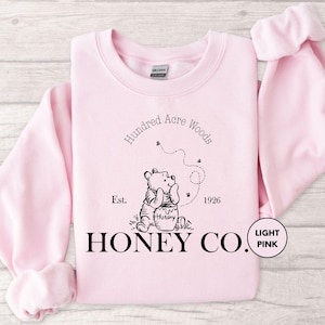 a pink sweatshirt with the words honey co printed on it