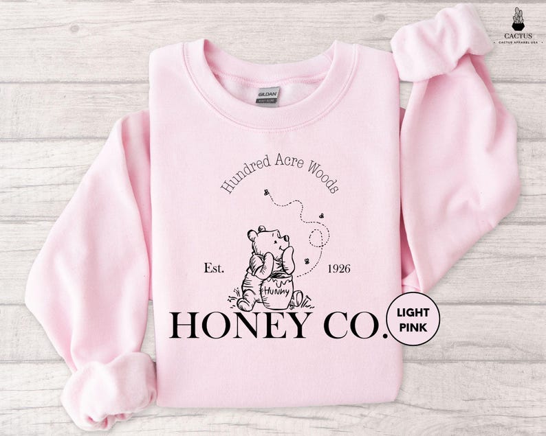 a pink sweatshirt with the words honey co printed on it