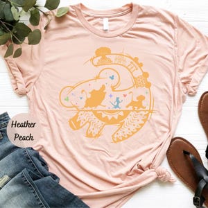 a pink t - shirt with an image of a fish on it