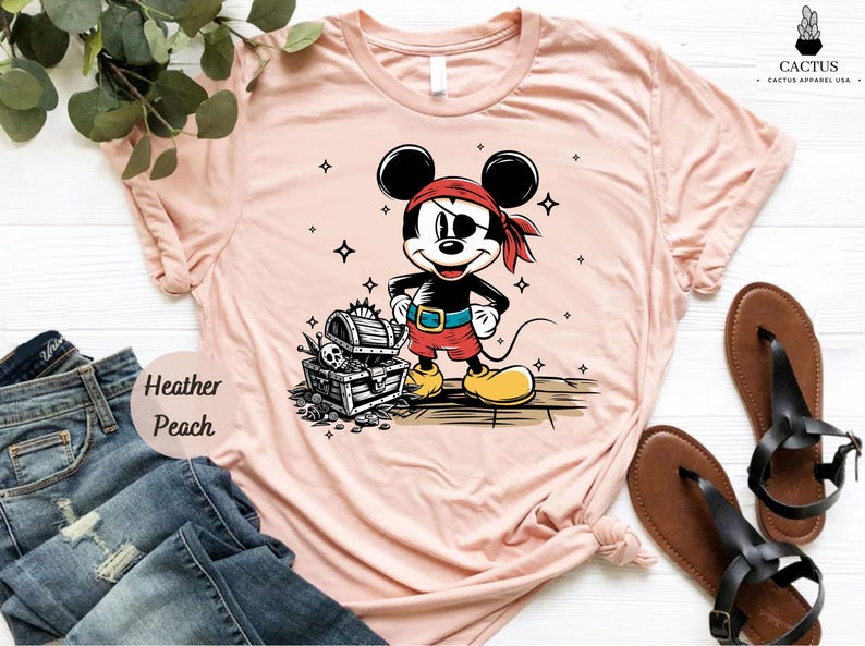 a pink shirt with a mickey mouse on it